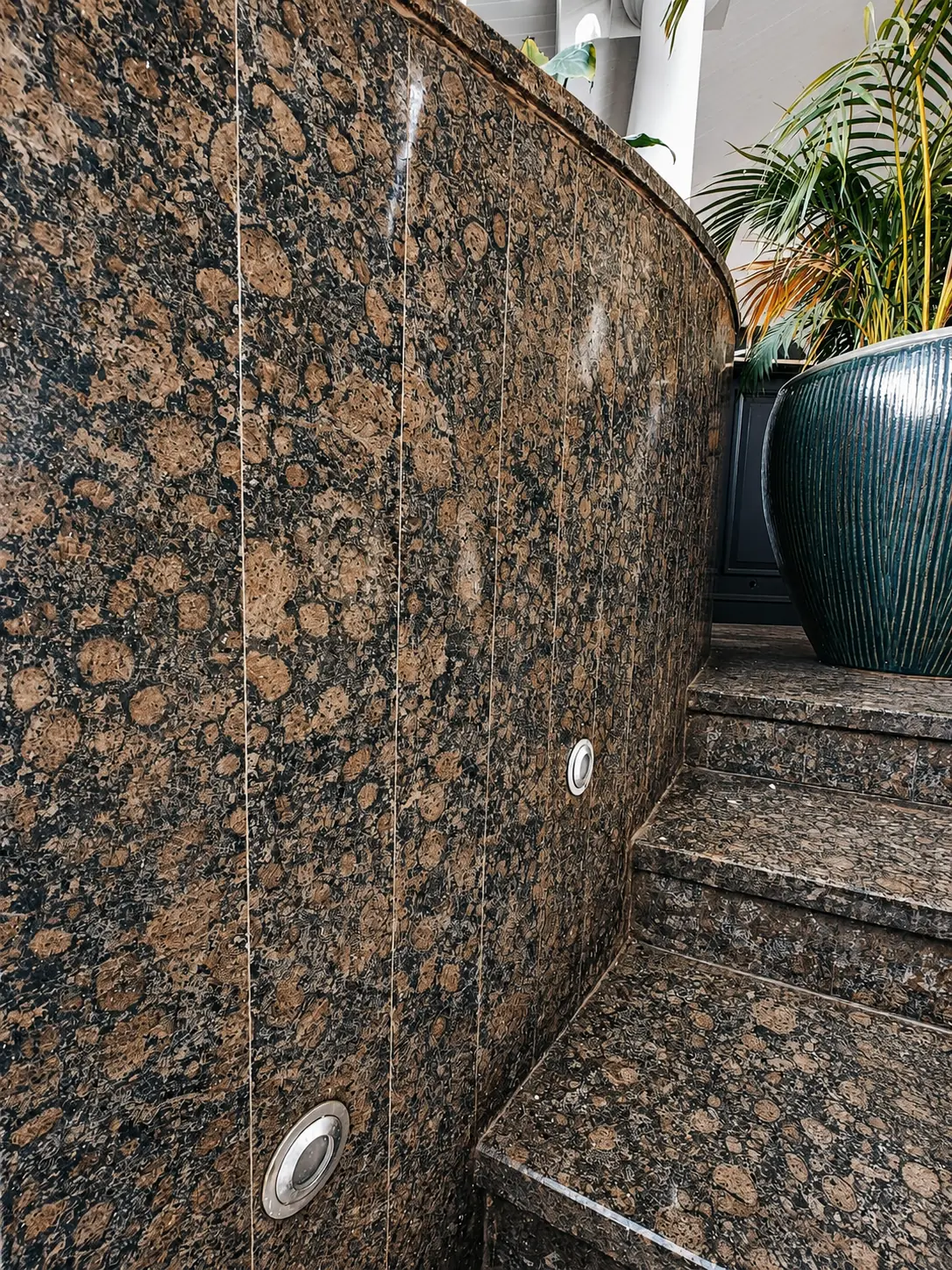 Brown patterned granite staircase and wall cladding after polishing