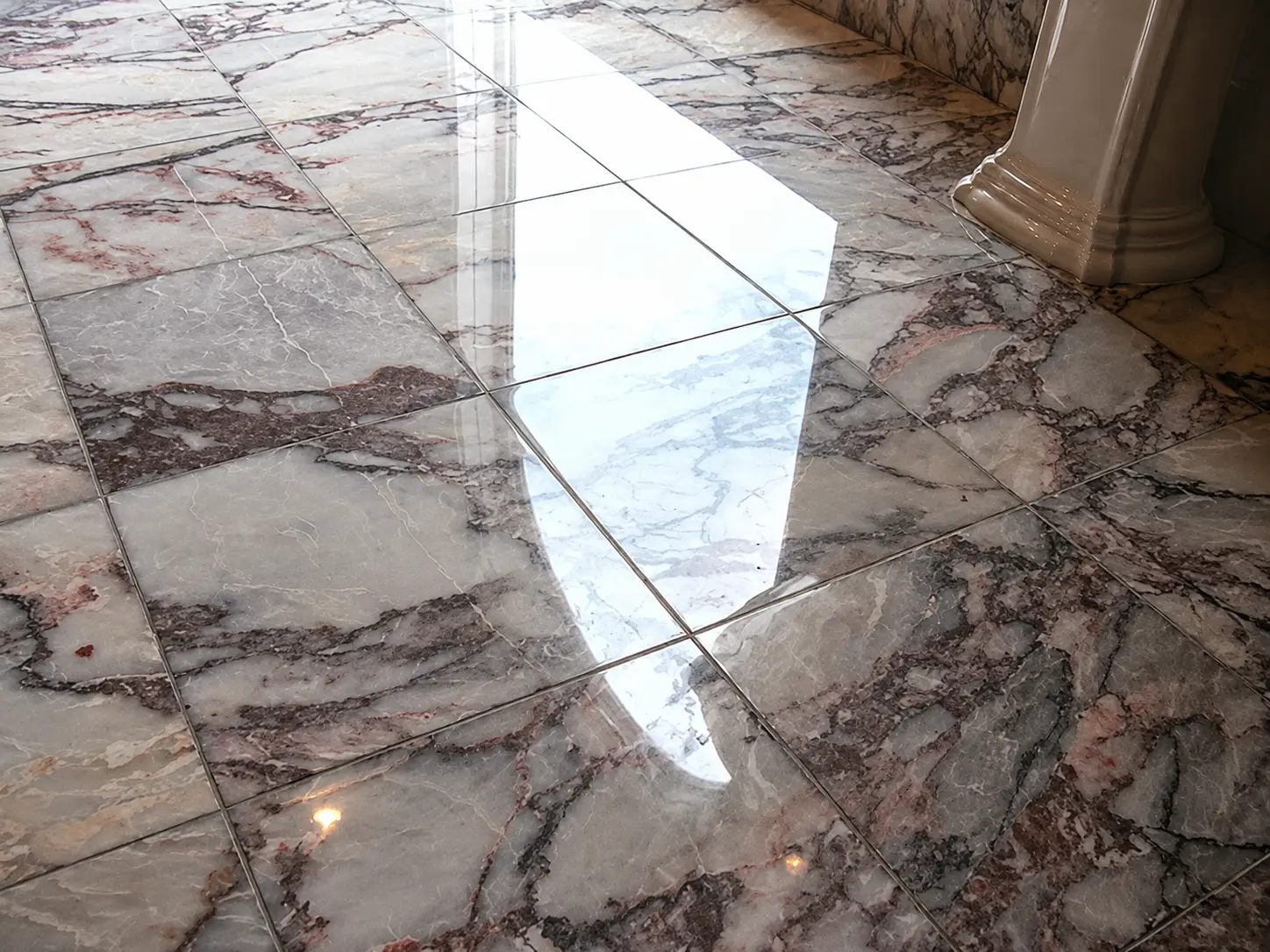 Pink-veined marble floor polished to reveal the natural stone pattern