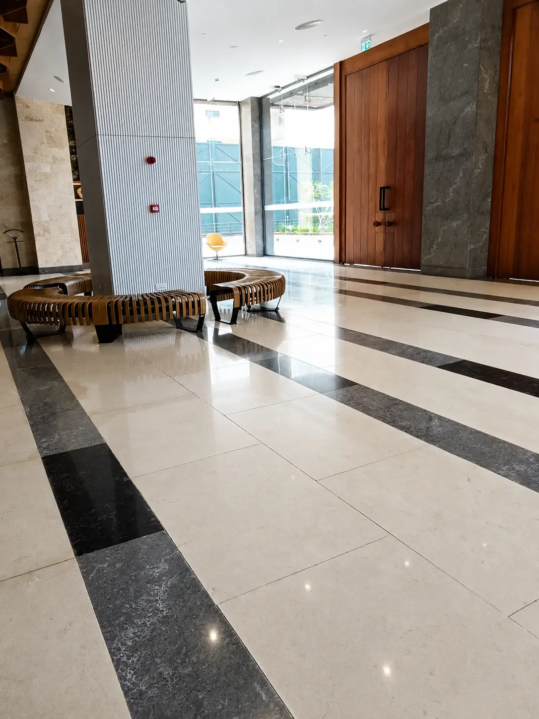 Black-and-cream marble entrance polished to a uniform sheen