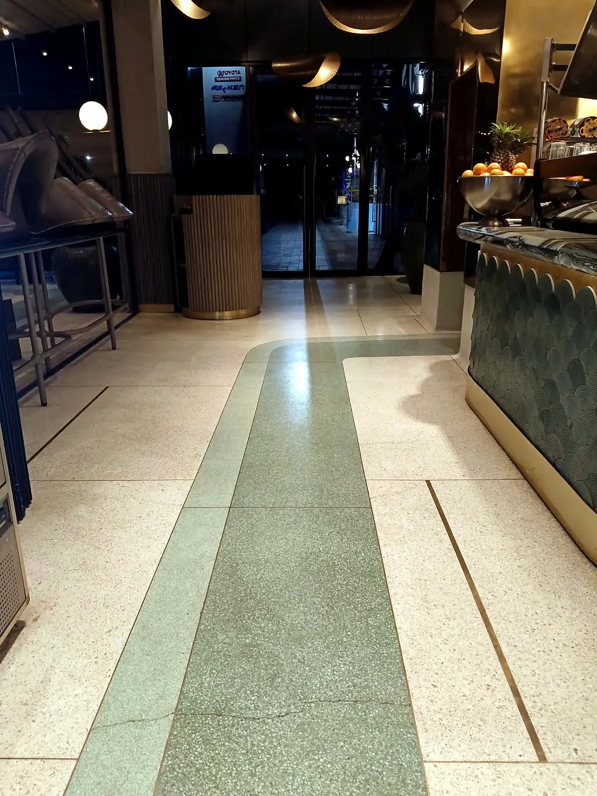 Green-and-cream terrazzo walkway with a consistent refined finish